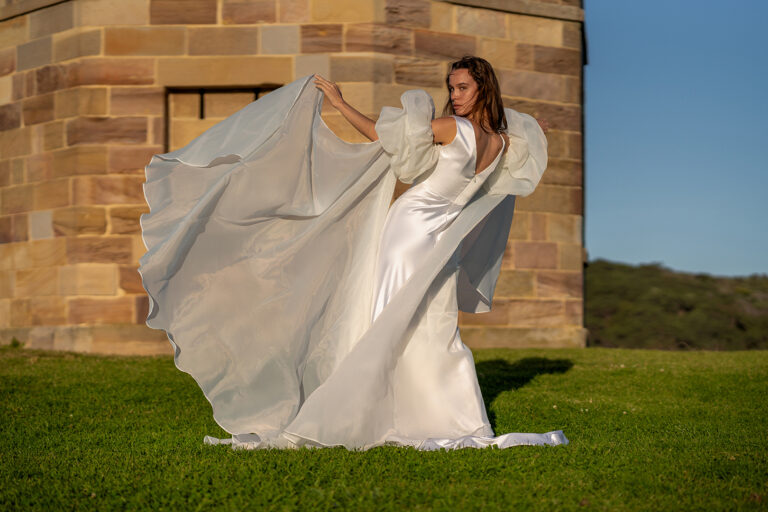 Woman wearing a stunning Roya Javaheri wedding gown with Angel detachable sleeves