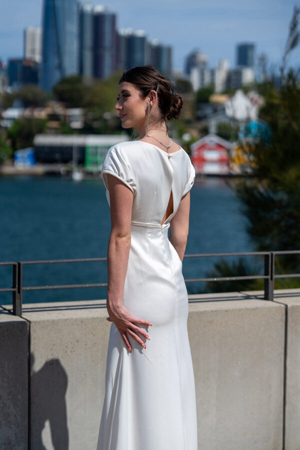 Woman posing in the stunning Lindy wedding dress by Roya Javaheri