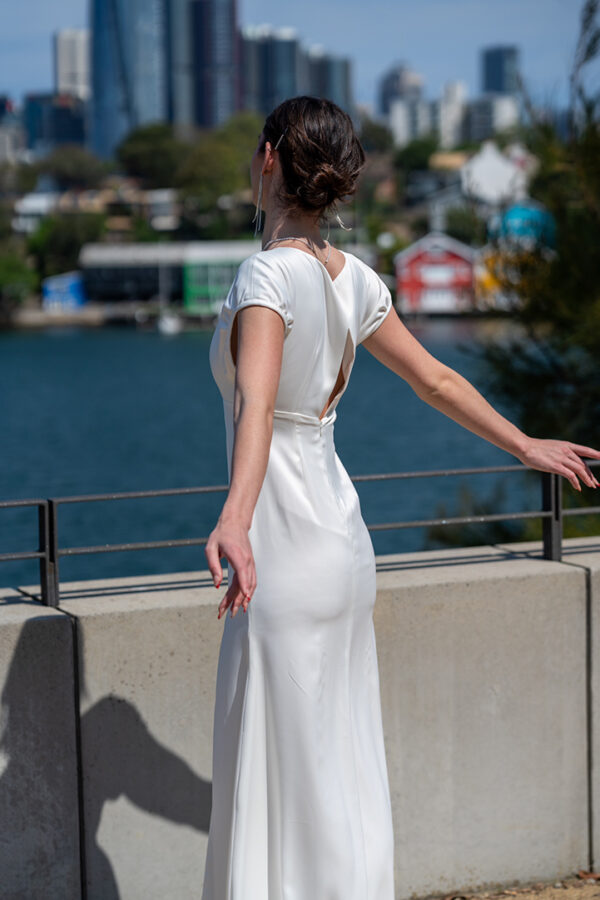 Woman posing in the stunning Lindy wedding dress by Roya Javaheri