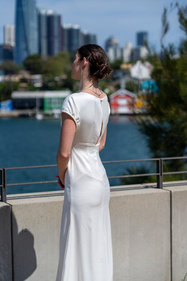 Woman posing in the stunning Lindy wedding dress by Roya Javaheri