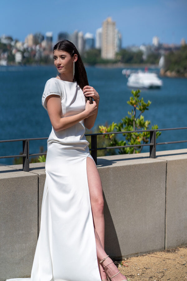 Woman posing in the stunning Lindy wedding dress by Roya Javaheri