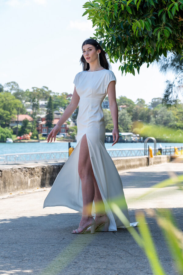 Woman posing in the stunning Lindy wedding dress by Roya Javaheri