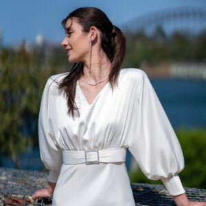 Woman posing in the stunning Erin wedding dress with sleeves by Roya Javaheri