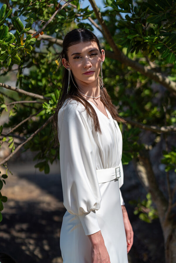 Woman posing in the stunning Erin wedding gown by Roya Javaheri