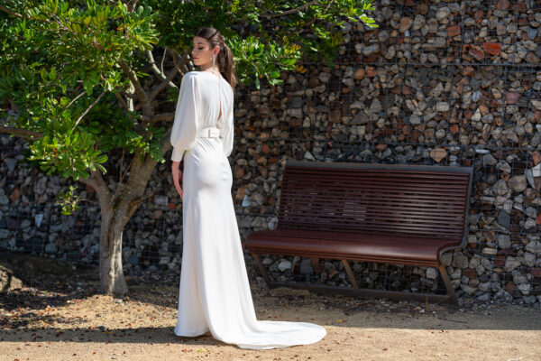 Woman posing in the stunning Erin wedding gown by Roya Javaheri