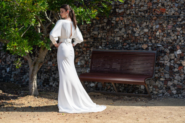 Woman posing in the stunning Erin wedding gown by Roya Javaheri