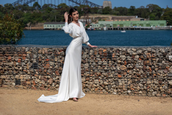 Woman posing in the stunning Erin wedding gown by Roya Javaheri