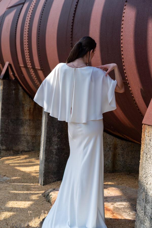 Woman posing in the stunning Enya wedding dress by Roya Javaheri