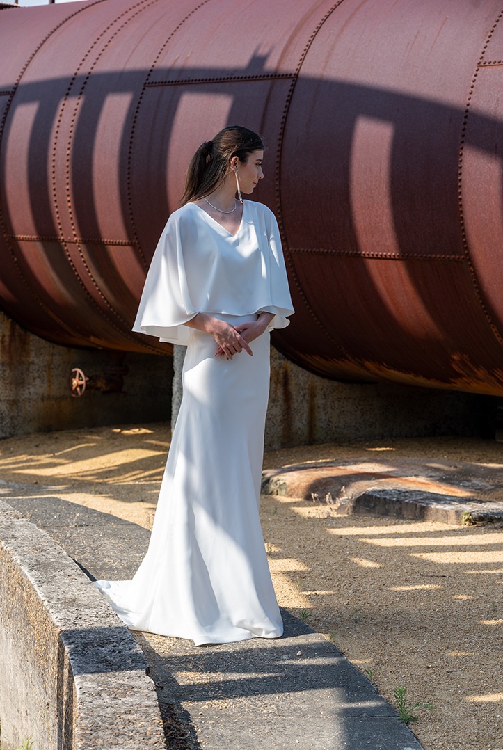 Woman posing in the stunning Enya wedding dress by Roya Javaheri