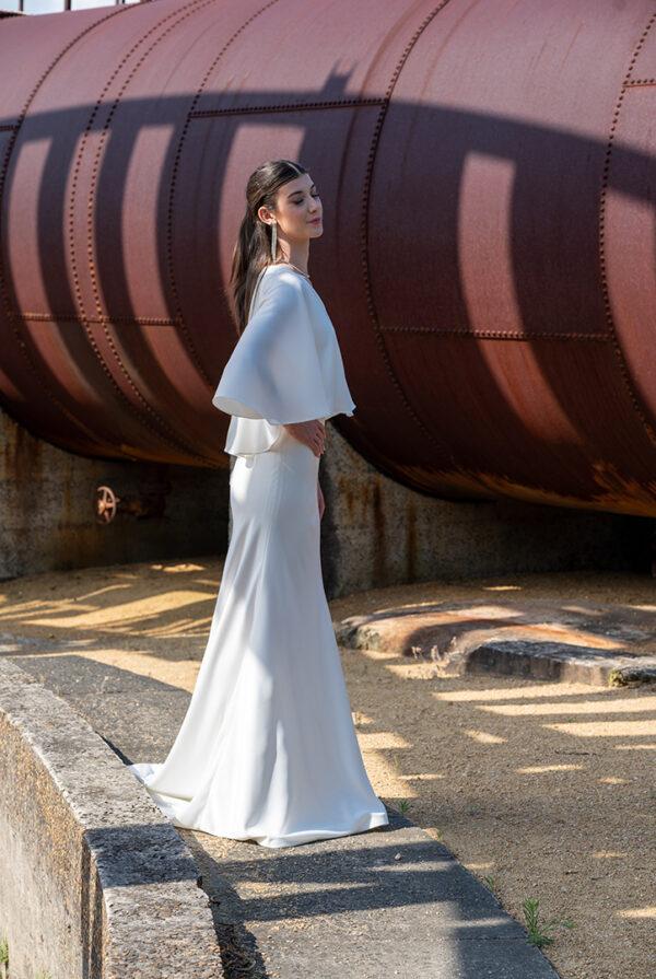 Woman posing in the stunning Enya wedding dress by Roya Javaheri