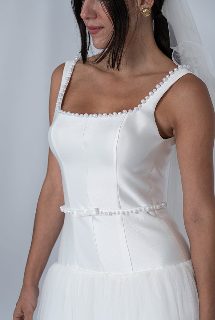 Structured square-neck wedding dress with pearl edging
